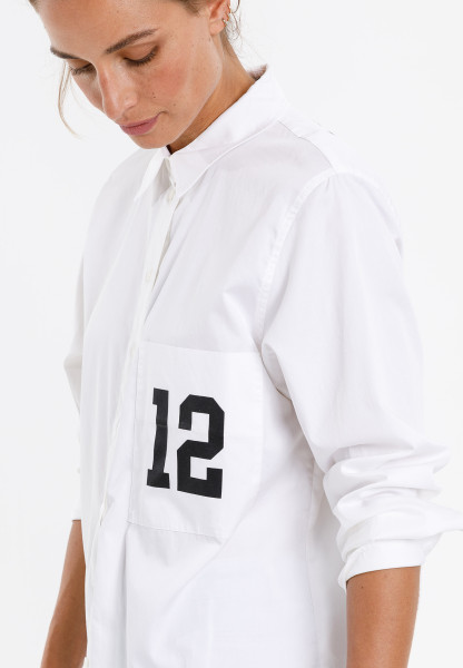 Oversized blouse with number print on the breast pocket